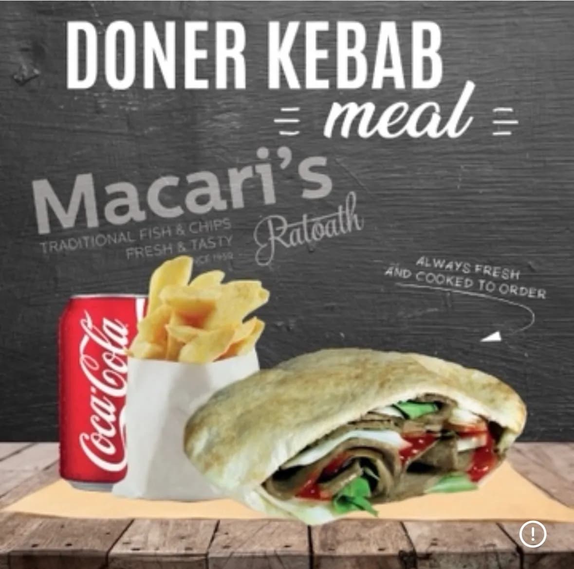 Doner kebab meal with chips and a can of Coca-Cola, served on a wooden table with a dark chalkboard-style background.